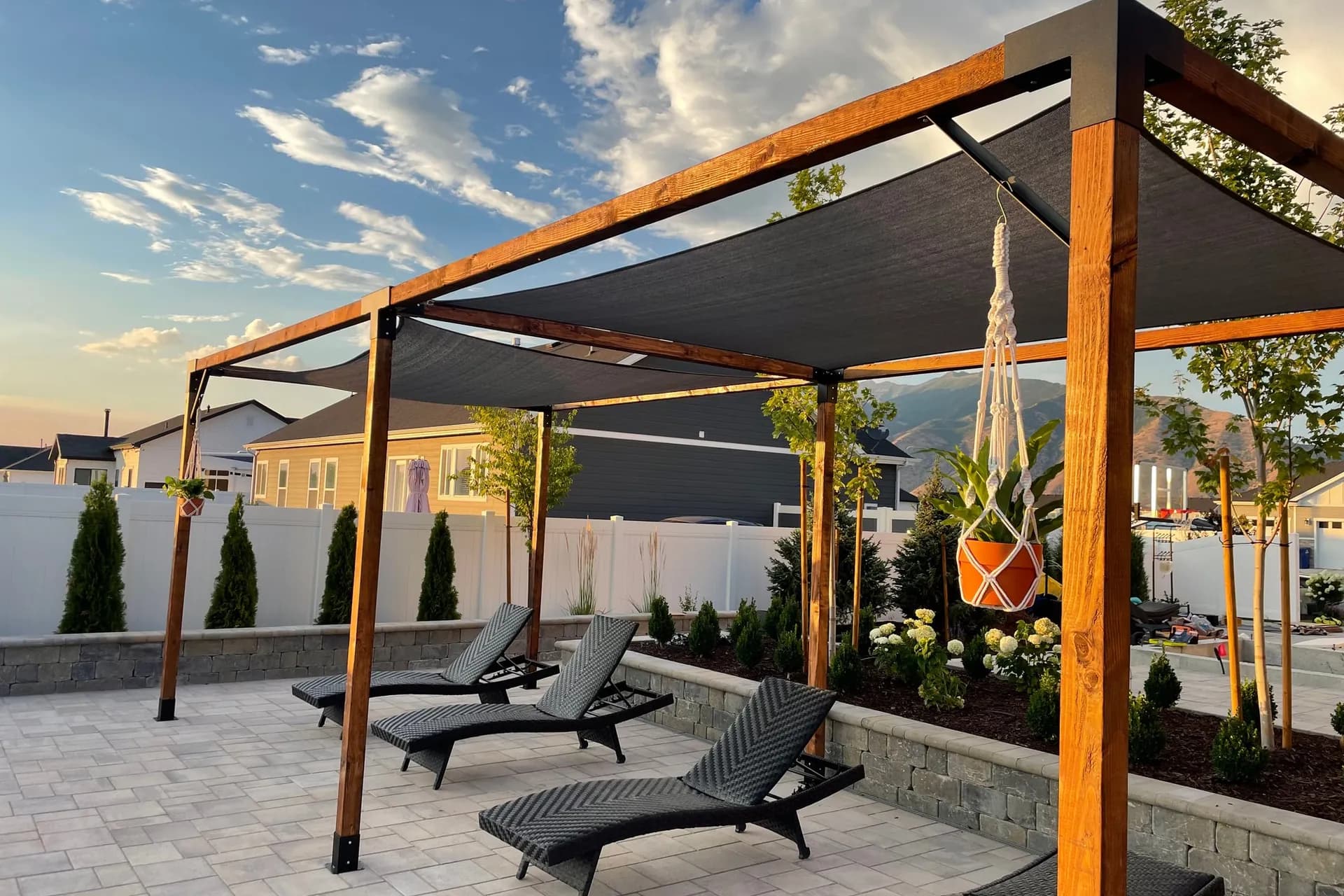 Bjørn Woodworks pergola with shade sail at dusk